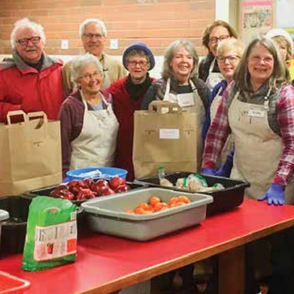 A group of volunteers prepares meals.